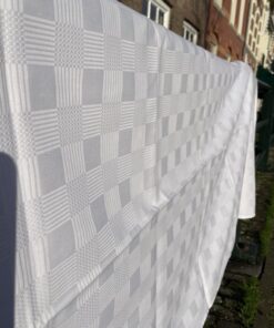 Wit katoenen tafelkleed geweven in blokmotief 245 x 175 cm met 16 bijbehorende servetten 44 x 44 cm.